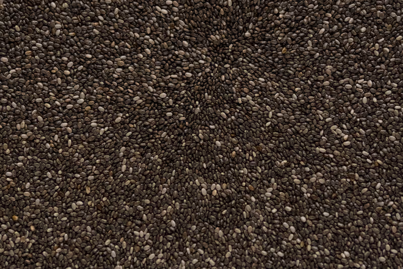 Close up of chia seeds in a wooden spoon